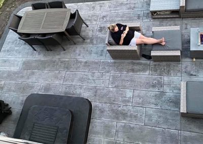 Wood and stone stamped concrete patio finished with furniture